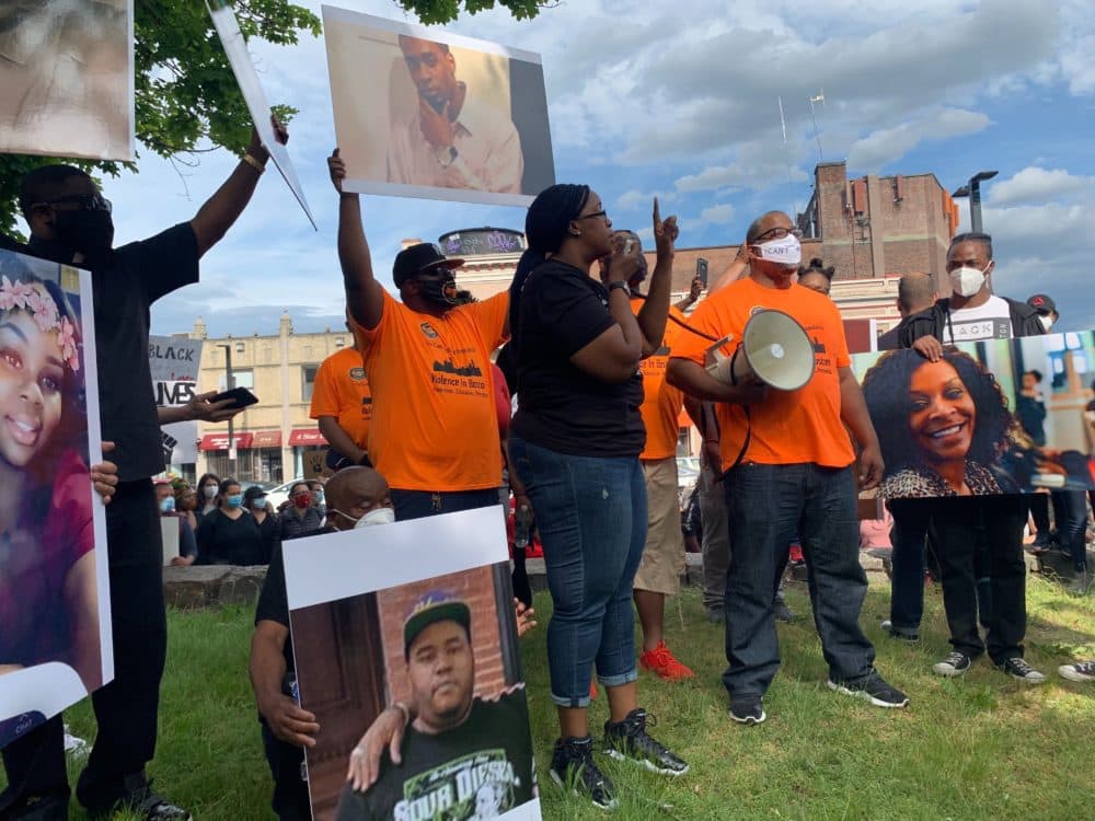 People attend a vigil and rally against police brutality near the Franklin Park Zoo in Boston. (Jesse Costa/WBUR)