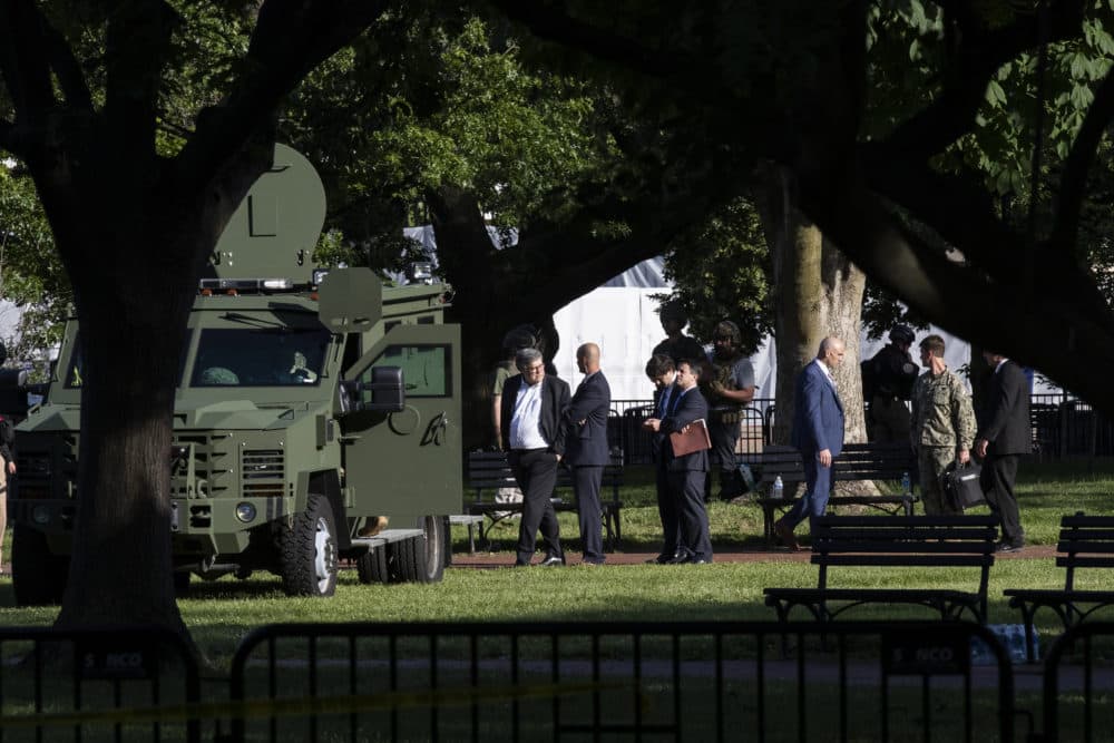 Attorney General William Barr, left, walks in Lafayette Park as demonstrators gather to protest the death of George Floyd near the White House on Monday. (AP Photo/Alex Brandon)