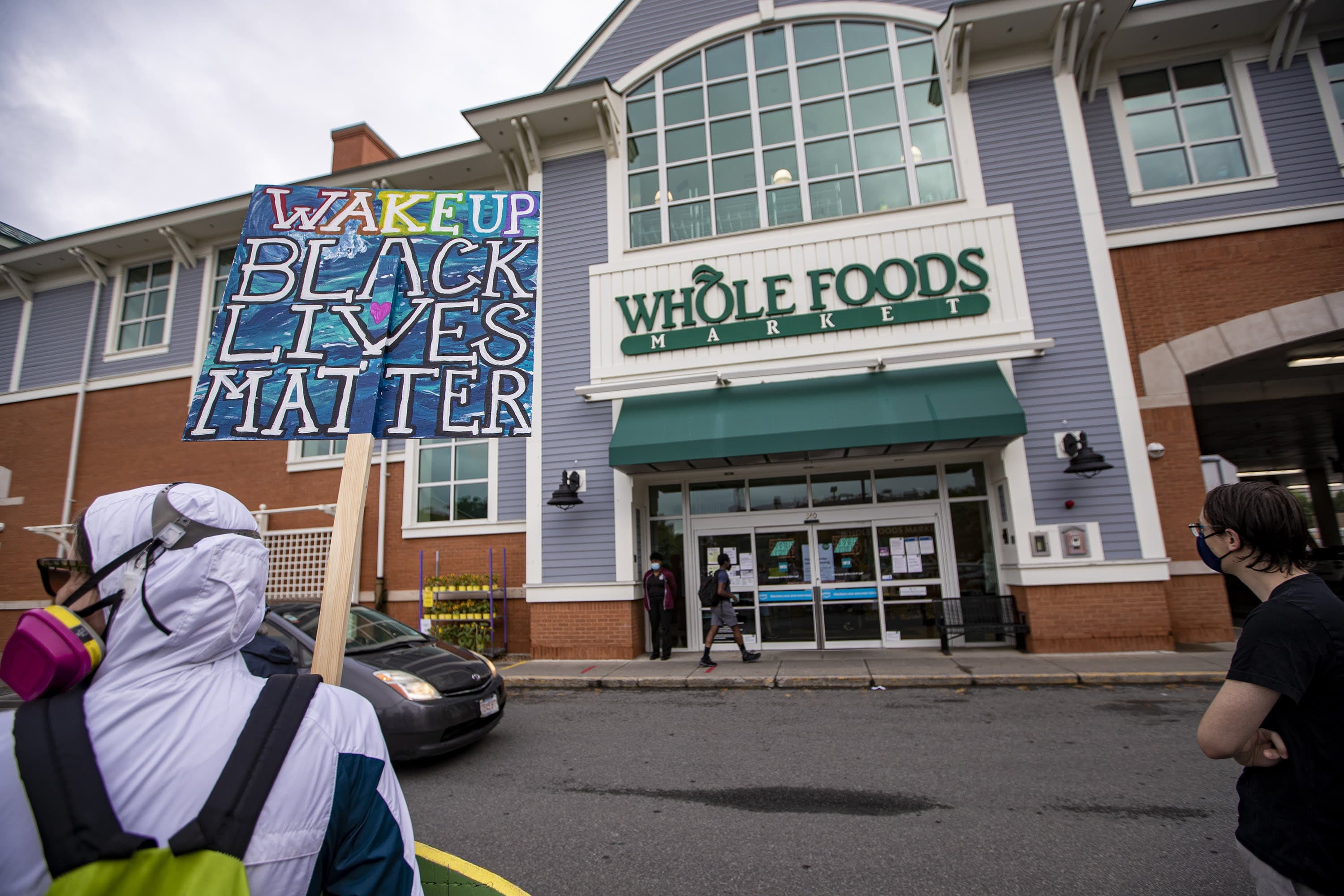 Supporters of employees wanting to wear Black Lives Matter masks during their shifts gathered outside the River St. Whole Foods in Cambridge in June 2020. (Jesse Costa/WBUR)