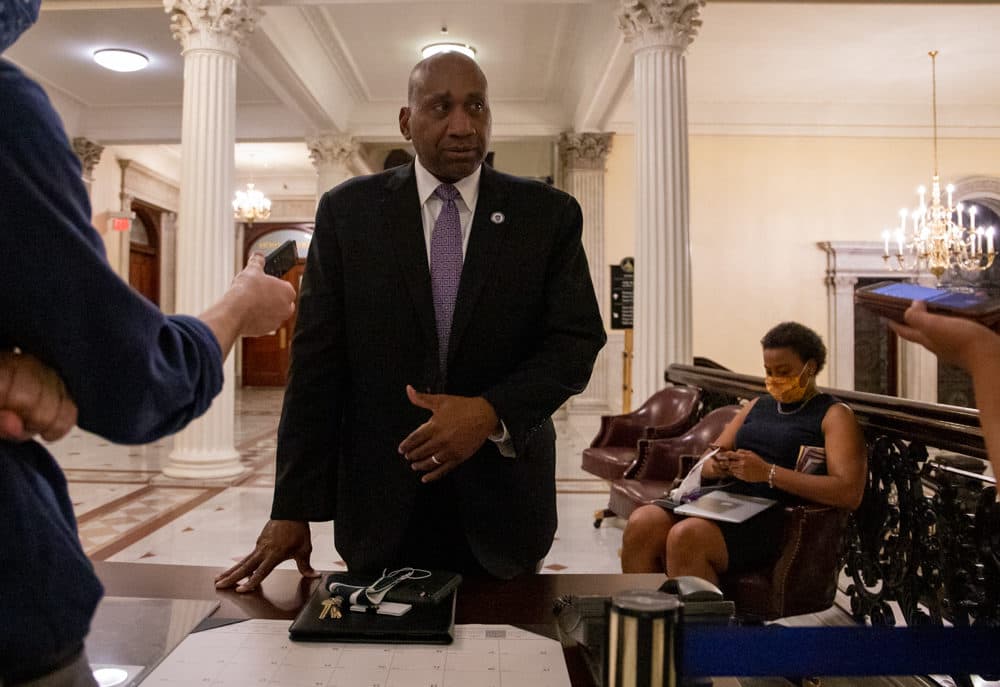 Rep. Russell Holmes, a past chairman of the Black and Latino Legislative Caucus, spoke to reporters after the end of the marathon session while Rep. Nika Elugardo sat nearby. (Sam Doran/SHNS)