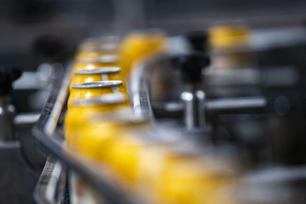 Cans of Blood Orange Wheat on the canning line at Jack’s Abby in Framingham. (Jesse Costa/WBUR)