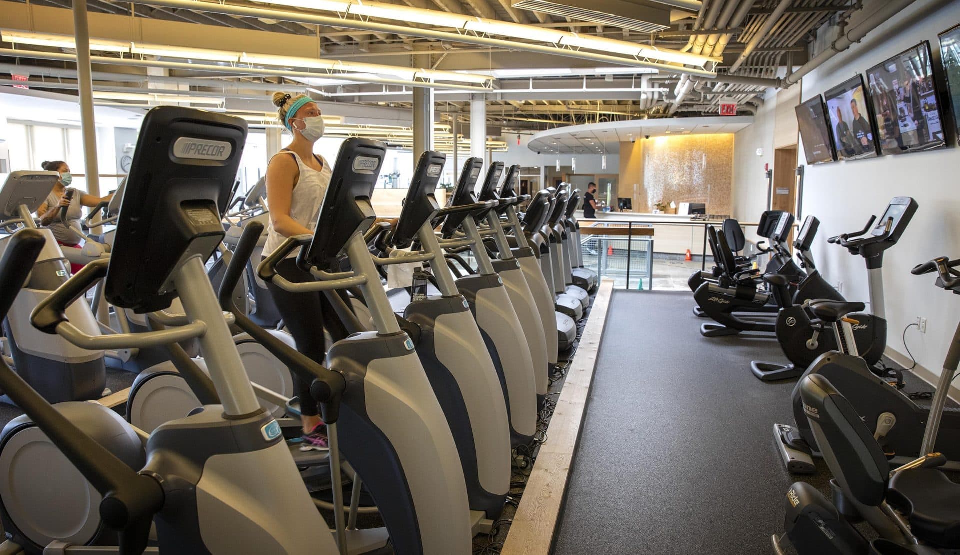 As gyms in Massachusetts start to open up again, Courtney Nowicki from Brookline gets back to her workout at Healthworks in Coolidge Corner. (Robin Lubbock/WBUR)