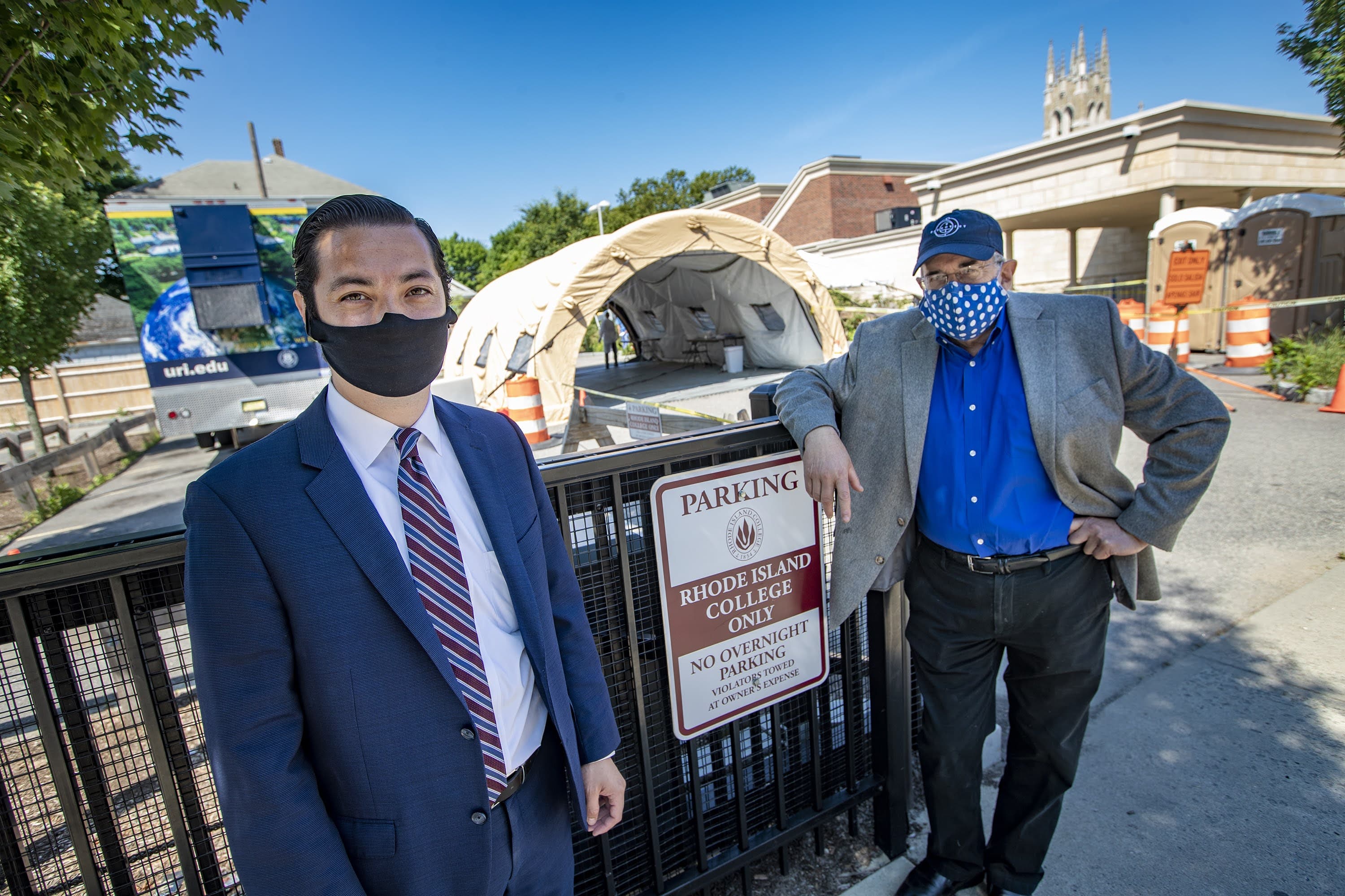 Central Falls Mayor James Diossa, left, and Dr. Michael Fine stand in front of the Rhode Island College walk-up testing site in Central Falls. (Jesse Costa/WBUR)