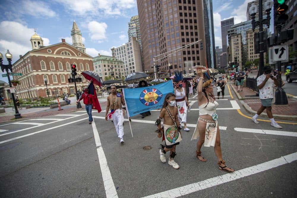 Protesters leave the plaza of Faneuil Hall to march down Congress Street towards Boston City Hall. (Jesse Costa/WBUR)