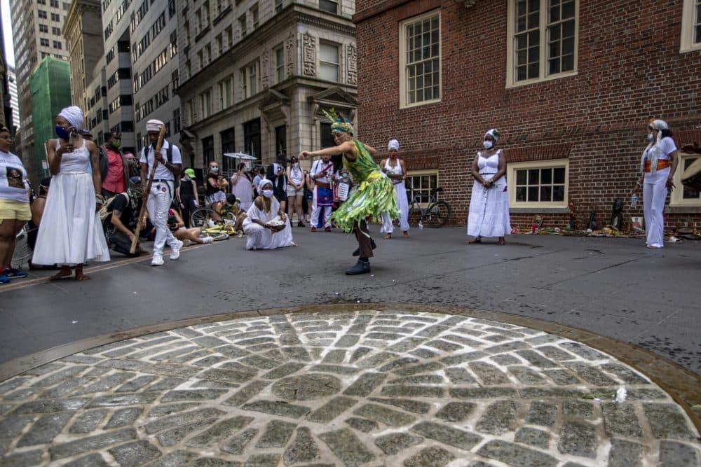 Protesters stop at the site of the Boston Massacre, to hold a celebration of indigenous song and dance. (Jesse Costa/WBUR)
