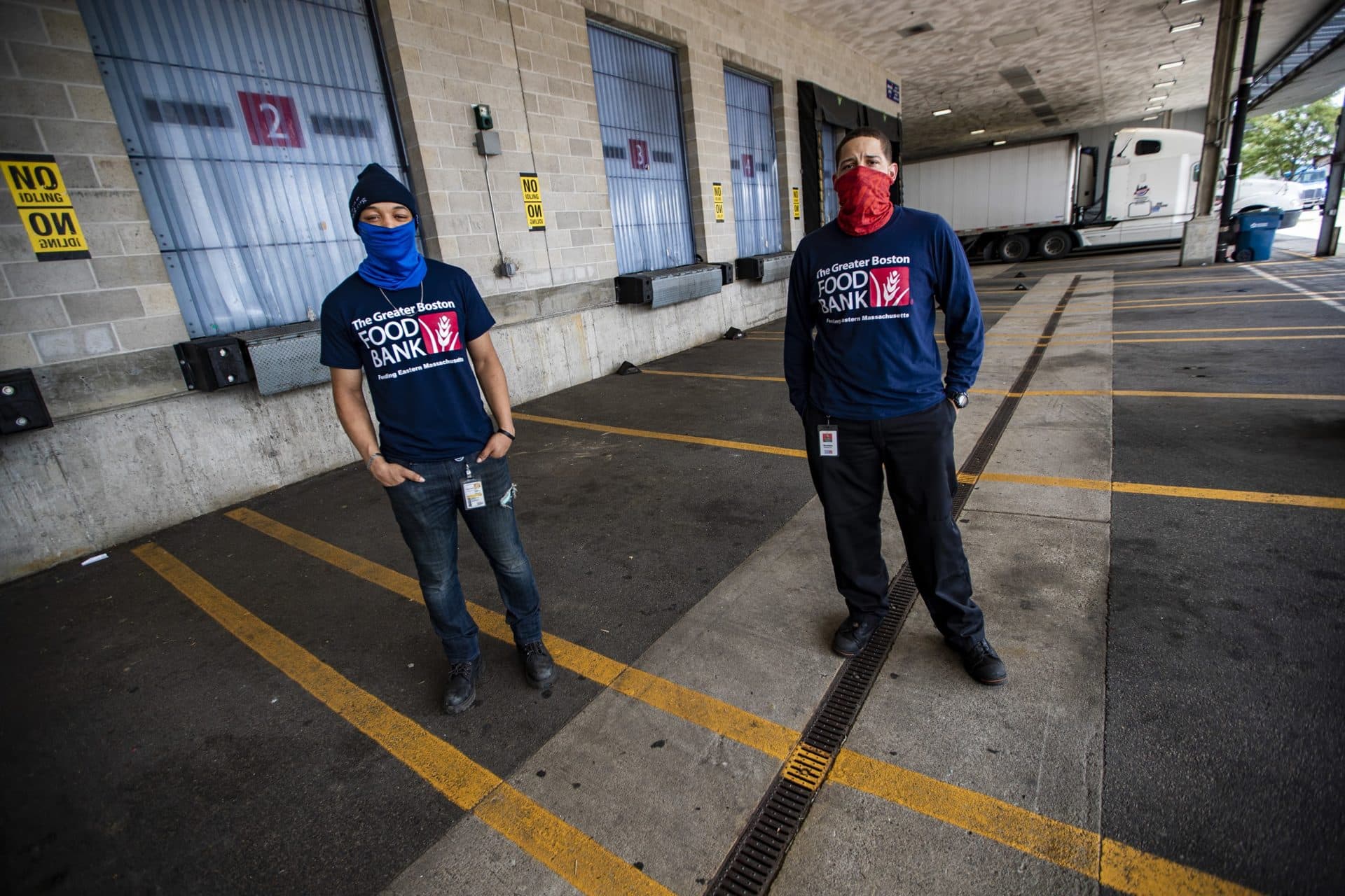 KC Hollis, left, and Damian Reynoso stand outside of the loading dock at the Greater Boston Food Bank. (Jesse Costa/WBUR)