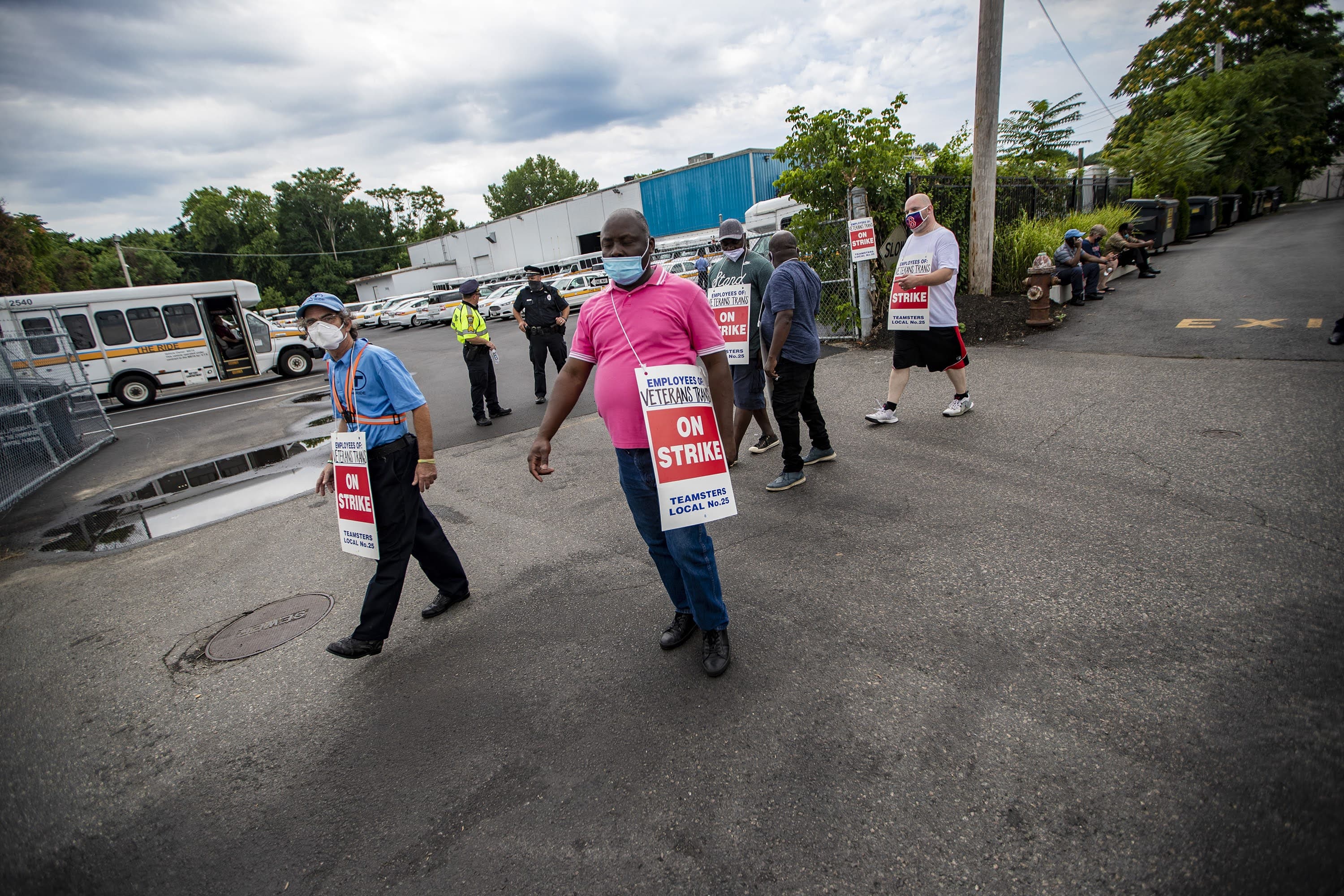 Drivers of Veterans Transportation who operate vehicles for the MBTA’s “The Ride” program, picket outside the company office in Watertown. (Jesse Costa/WBUR)