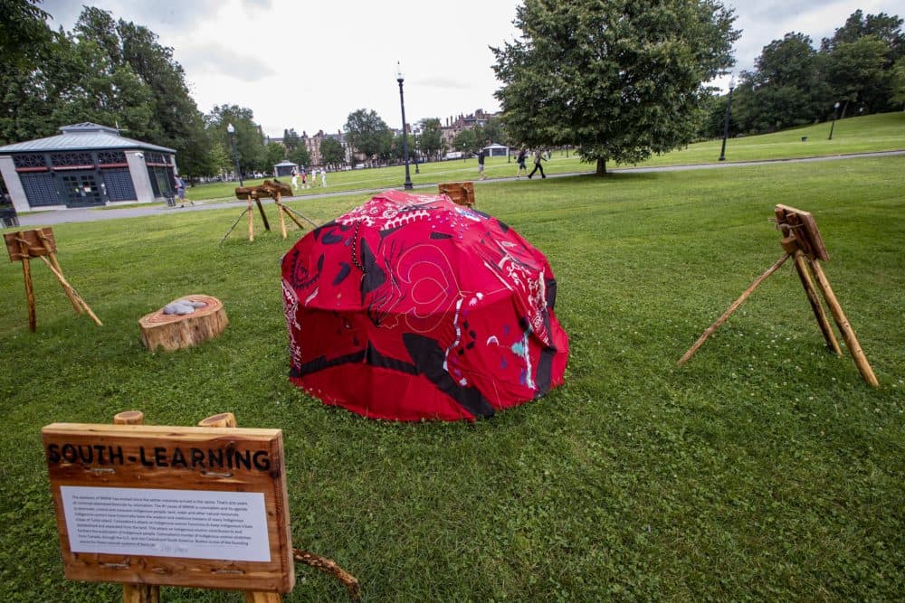 The art installation “Red Dress Lodge,” by Lilly Manycolors, is on display at the Boston Common. (Jesse Costa/WBUR)