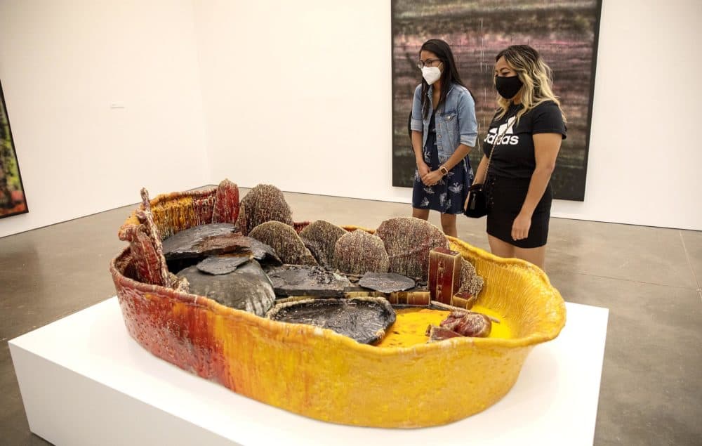 Midaly Carrsaquillo and Chanthy Ngin look at a basin from Sterling Ruby's &quot;Basin Theology&quot; at the ICA. (Robin Lubbock/WBUR)