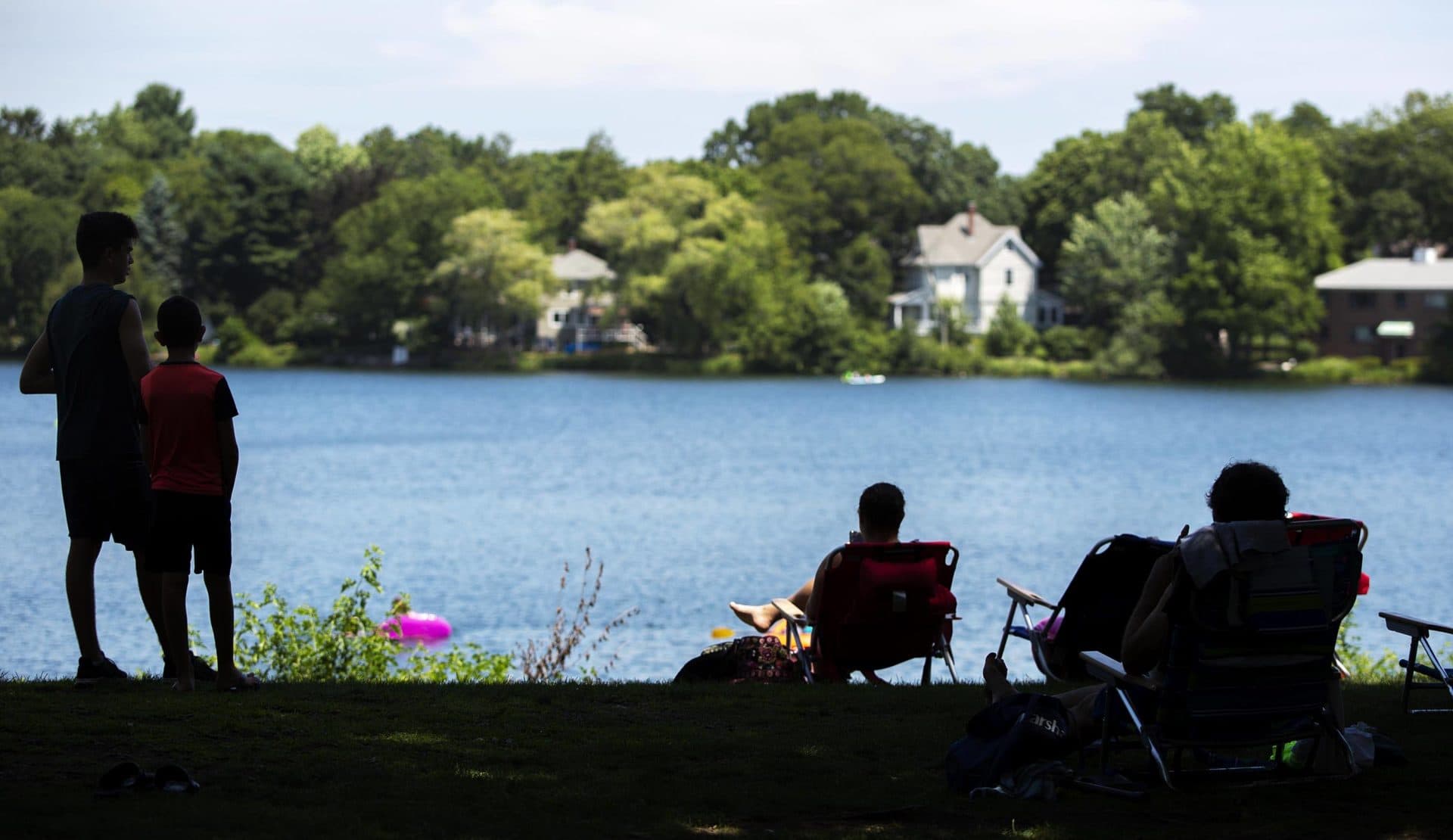 Visitors to Crystal Lake in Newton stay in the shade to keep out of the heat. (Robin Lubbock/WBUR)