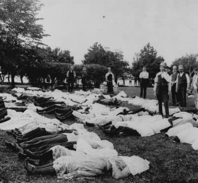 Bodies of the victims of the General Slocum are laid out on nearby ground. (AP)
