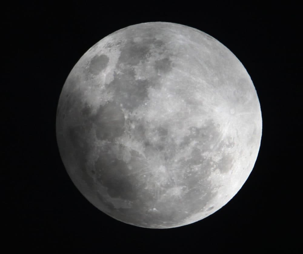 In this Monday Feb. 9, 2009 file photo, a faint shadow from the Earth is cast over part of the moon during a penumbral lunar eclipse, seen from Manila, Philippines. (Bullit Marquez/AP)