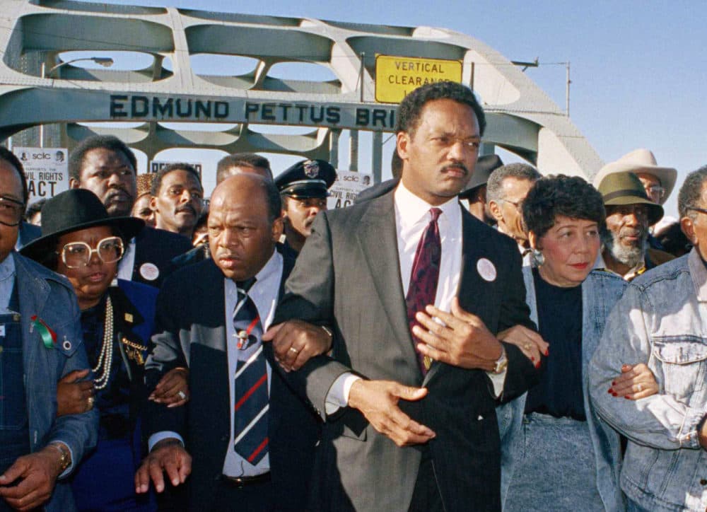 In this March 4, 1990 file photo, civil rights figures lead marchers across the Edmund Pettus Bridge during the recreation of the 1965 Selma to Montgomery march in Selma, Ala. From left are Hosea Williams of Atlanta, Georgia Congressman John Lewis, Rev. Jesse Jackson, Evelyn Lowery, SCLC President Joseph Lowery and Coretta Scott King. (Jamie Sturtevant/AP Photo)