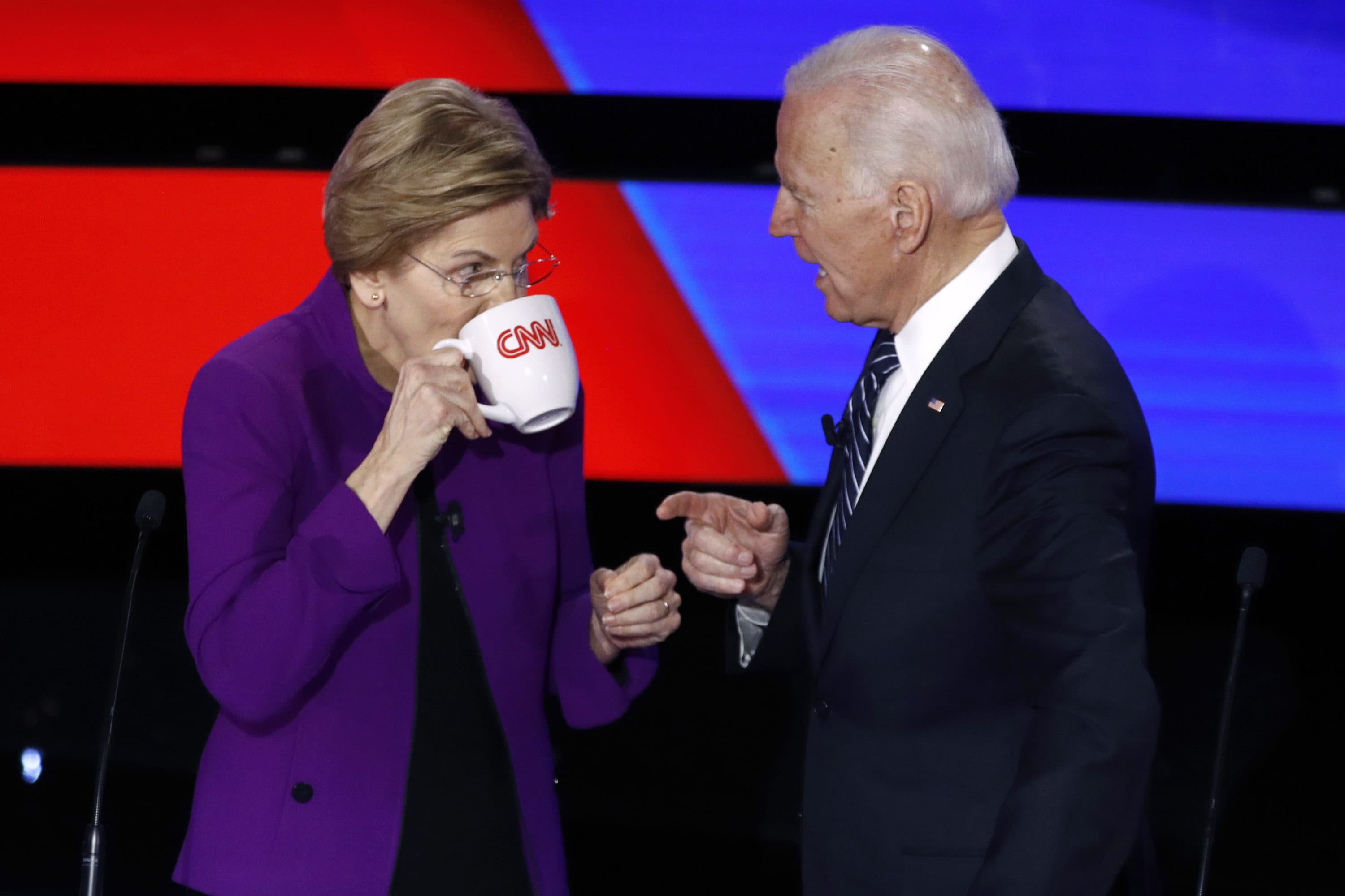 Democratic presidential candidates Sen. Elizabeth Warren, D-Mass., left, and former Vice President Joe Biden talk during a break, Jan. 14, 2020, in a Democratic presidential primary debate hosted by CNN and the Des Moines Register in Iowa. (Patrick Semansky/AP)