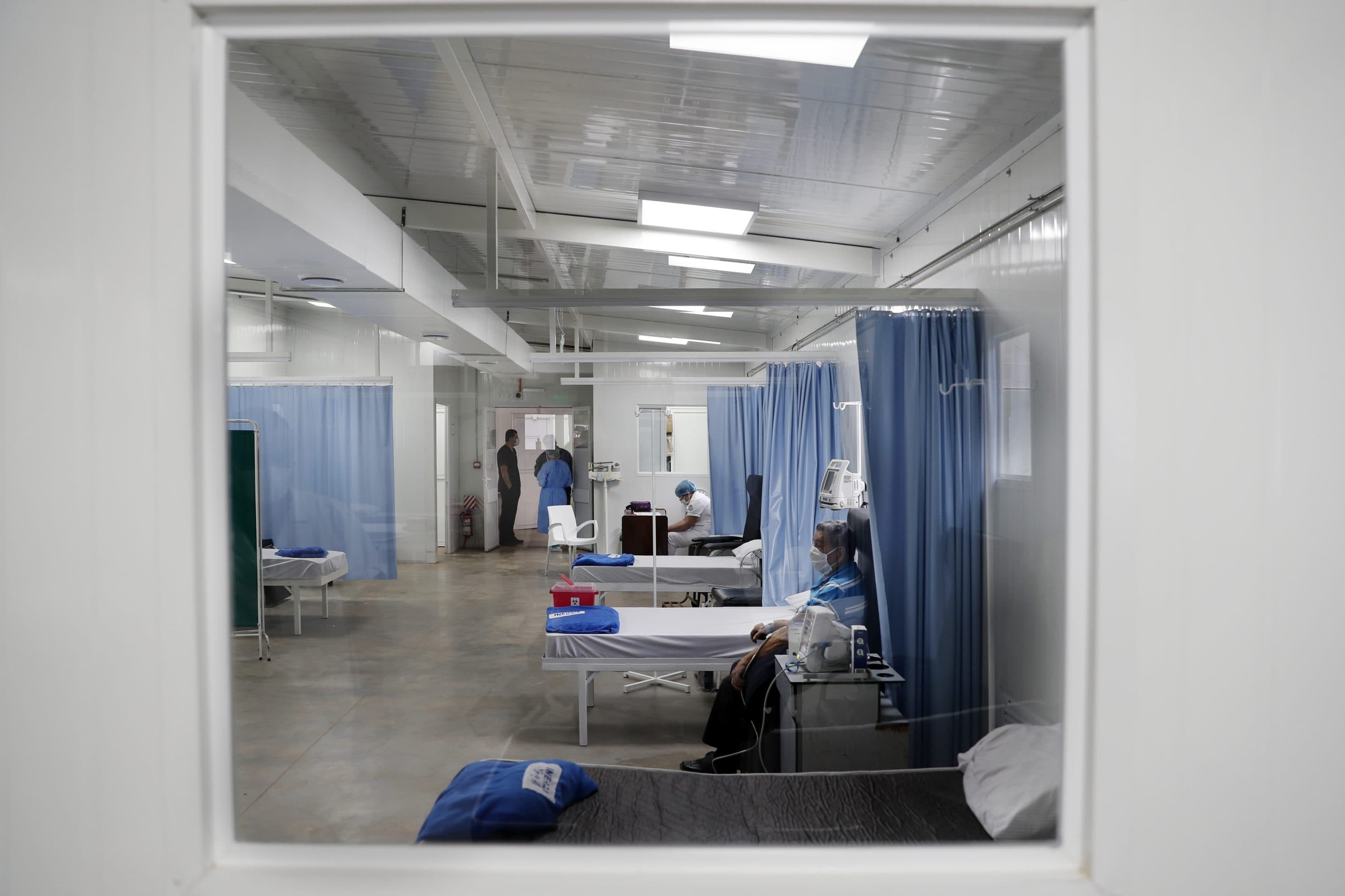 An elderly man recovers from a respiratory illness in a special section built for COVID-19 patients. (Jorge Saenz/AP)