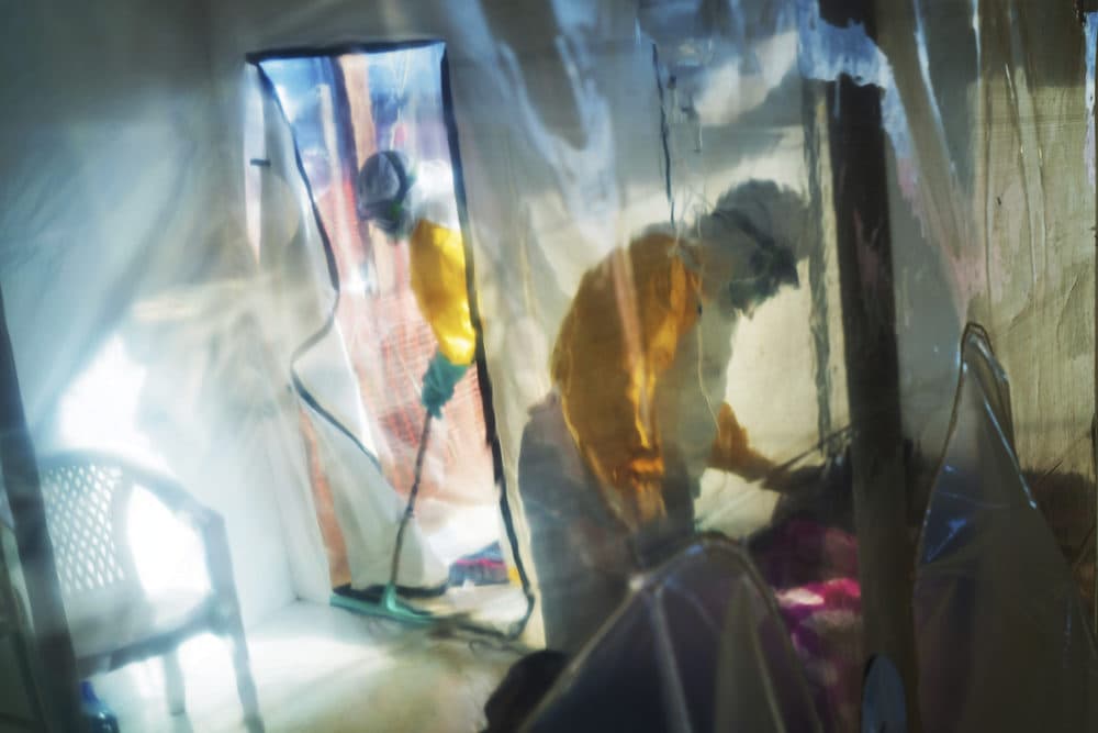 In this July 13, 2019 file photo, health workers wearing protective suits tend to an Ebola victim kept in an isolation tent in Beni, Congo. (Jerome Delay/AP)