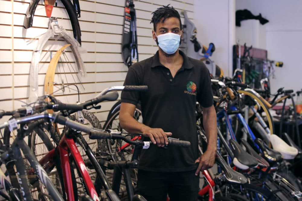 In this June 24, 2020, photograph, Noah Hicks, owner of Spokehouse Bikes in the Upham's Corner neighborhood of Boston, poses at his shop. Many from outside Boston have donated to and shopped at the store which was robbed and vandalized earlier in the month. (Charles Krupa/AP)