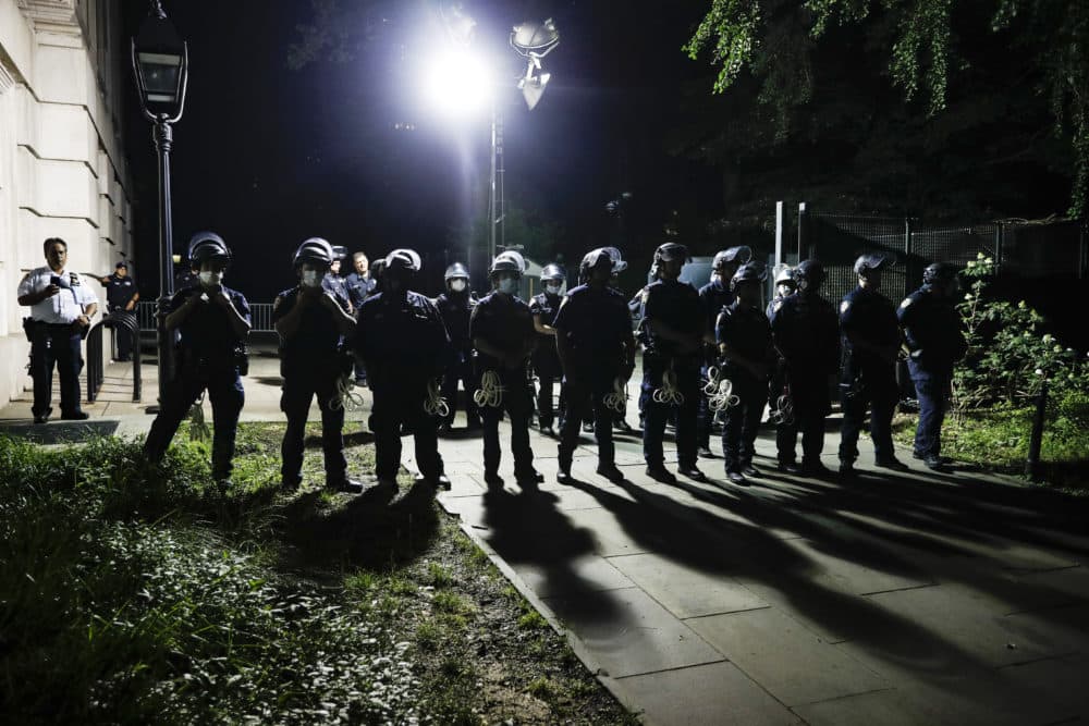 Police officers stand guard at City Hall as protesters gather near an encampment outside, Tuesday, June 30, 2020, in New York. (John Minchillo/AP)