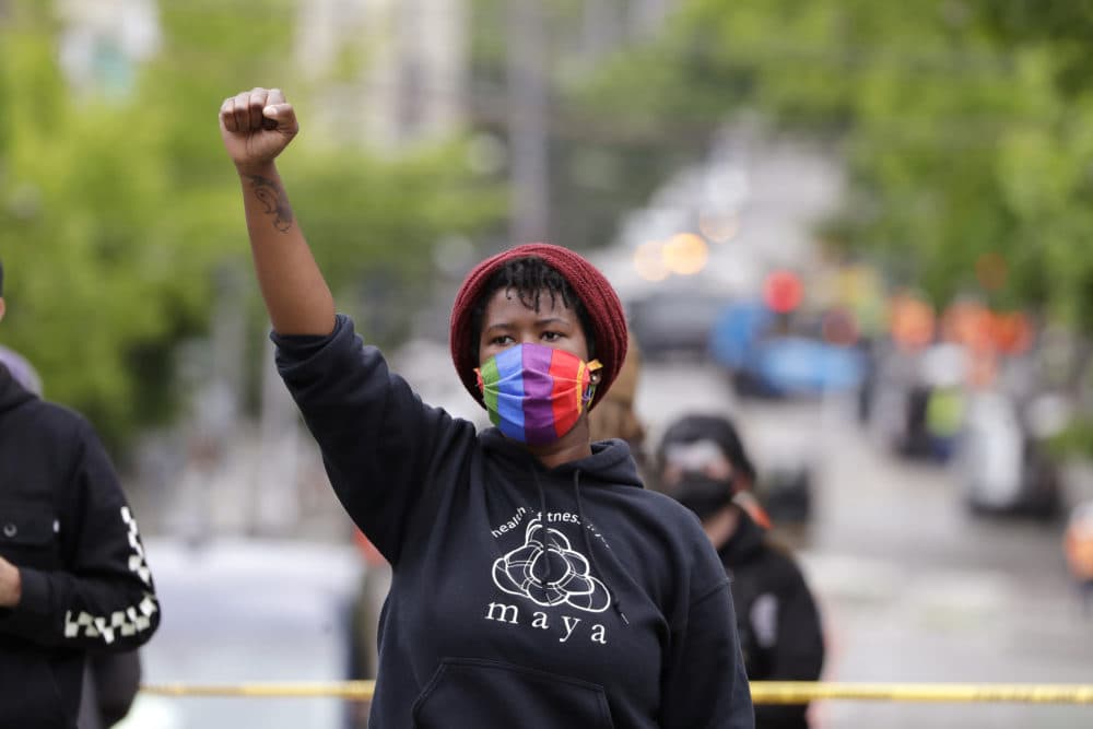 Demonstrator Elisha Ewing raises a fist as she stands during a protest Wednesday, July 1, 2020, in Seattle, where streets had been blocked off in an area demonstrators had occupied for weeks. (Elaine Thompson/AP)