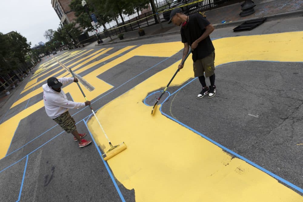 Lee Beard, left, and Paul &quot;Mars&quot; Chapman paint the phrase &quot;Black Lives Matter&quot; on Washington Street, July 5. (AP Photo/Michael Dwyer)