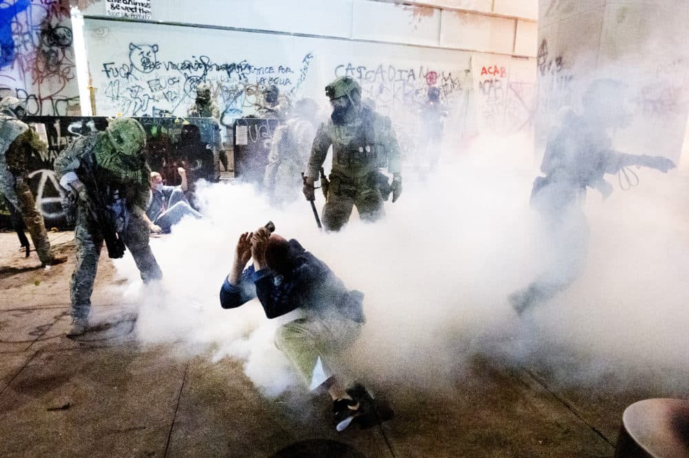 Federal officers use chemical irritants and crowd control munitions to disperse Black Lives Matter protesters outside the Mark O. Hatfield United States Courthouse on July 22, 2020, in Portland. (Noah Berger/AP)