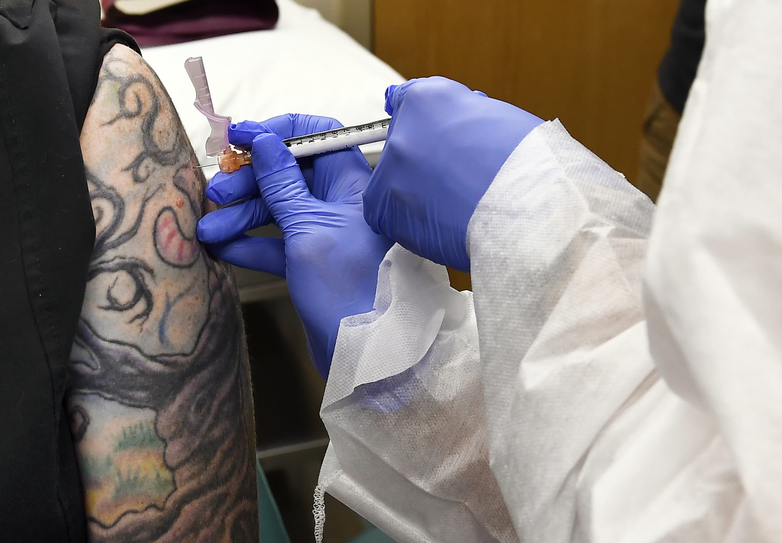 Nurse Kathe Olmstead, right, gives volunteer Melissa Harting, of Harpersville, N.Y., an injection as the world's biggest study of a possible COVID-19 vaccine, developed by the National Institutes of Health and Moderna Inc., gets underway Monday, July 27, 2020, in Binghamton, N.Y. (Hans Pennink/AP Photo)