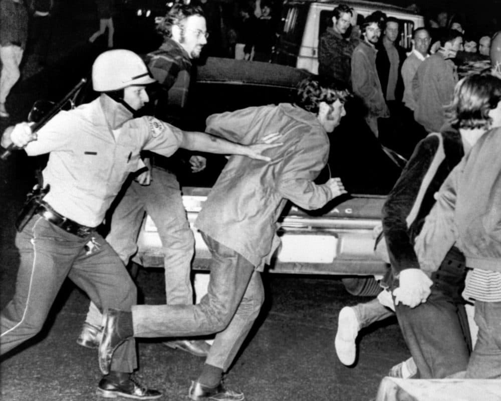 A Chicago police officer, his nightstick raised, chases a demonstrator in Chicago on August 27, 1968, as a large group of protestors battle law officers. Tear gas also was used to break up the demonstrators. (AP file photo)