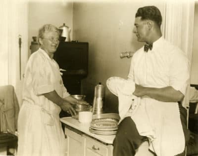 Lou Gehrig dries dishes for his mother, Christina. The Oakland Tribune used this photo to announce Lou Gehrig's columns. (Courtesy of National Baseball Hall of Fame)