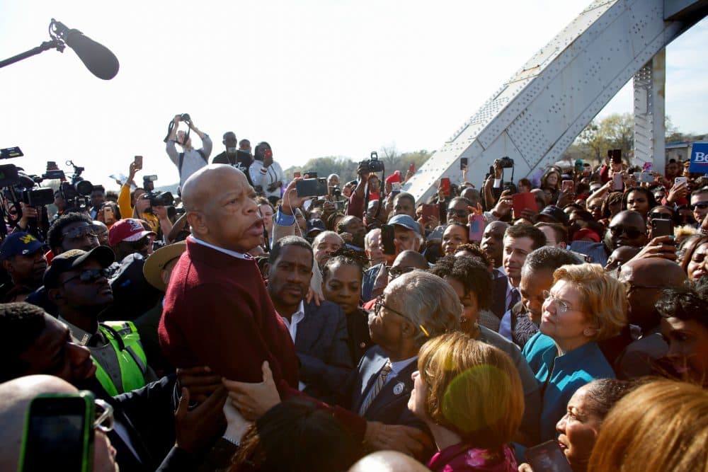 Former South Bend Mayor Pete Buttigieg (3r top), Reverend Al Sharpton, and Sen. Elizabeth Warren (D-MA) (R) listen to Rep. John Lewis (D-AL) speak as they march march during the Annual Bloody Sunday March across the Edmund Pettus Bridge in Selma, Alabama on March 1, 2020. (Joshua Lott/AFP/Getty Images) 