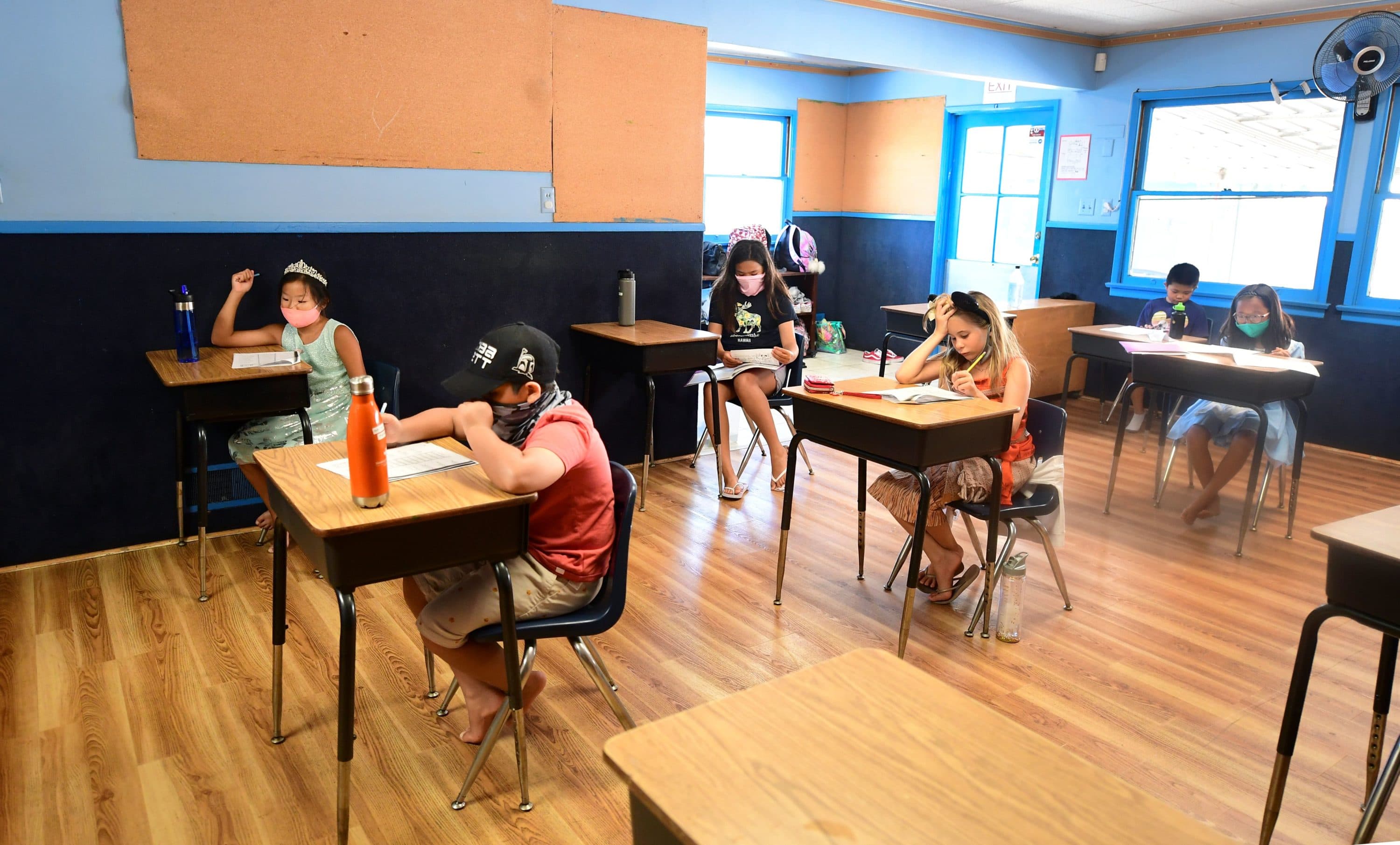 Children in an elementary school class wear masks and sit as desks spaced apart as per coronavirus guidelines during summer school sessions in Monterey Park, California on July 9, 2020. (Frederic J. Brown/AFP via Getty Images)