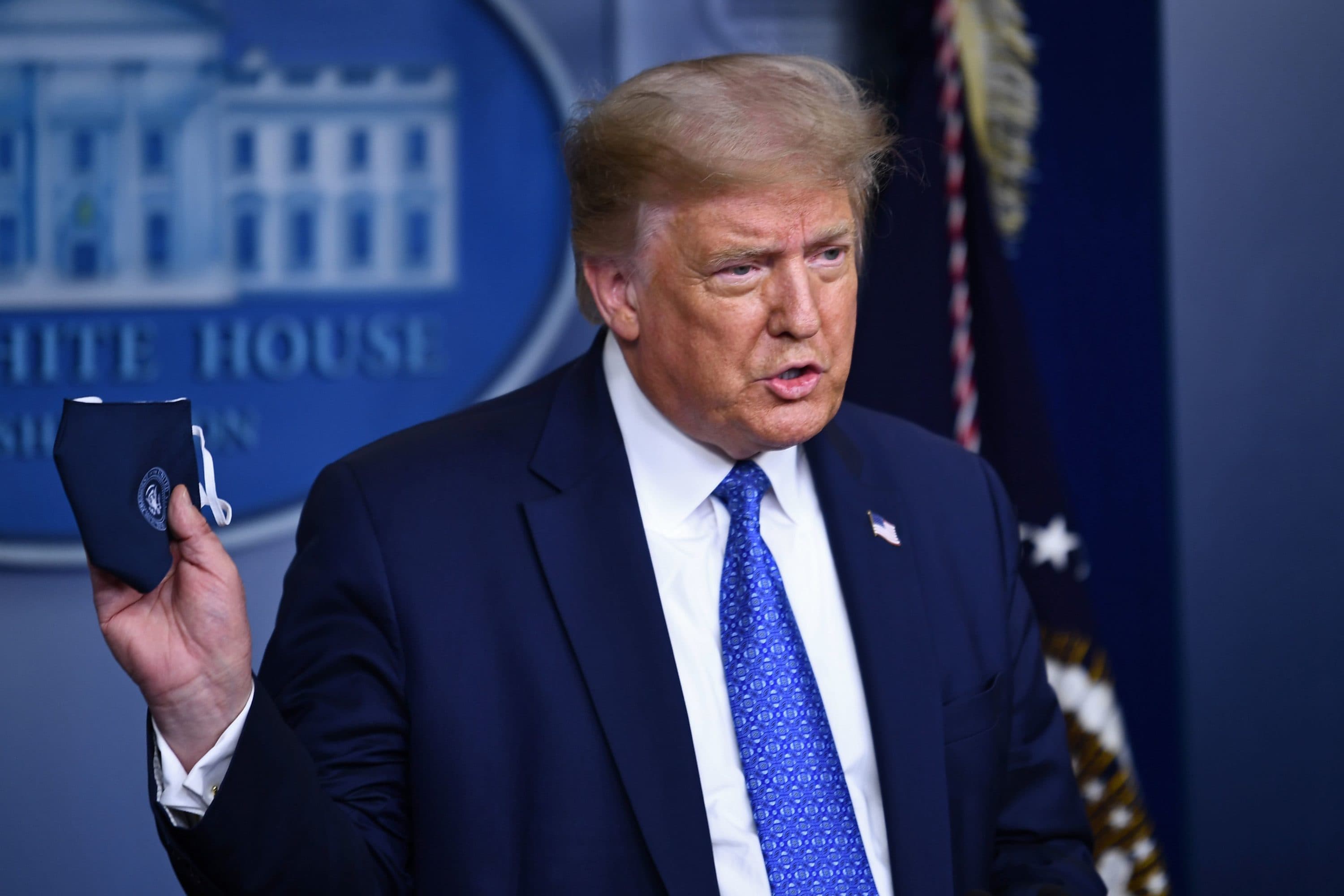 US President Donald Trump holds a facemask as he speaks to the press during the renewed briefing of the Coronavirus Task Force in the Brady Briefing Room of the White House in Washington, DC, on July 22, 2020. (Brendan Smialowski/AFP)