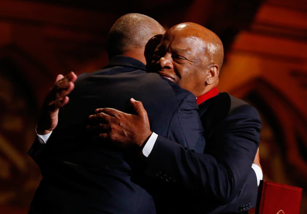 Congressman John Lewis, right, hugs former Governor Deval Patrick during the Hutchins Center Honors W.E.B. Du Bois Medal Ceremony in Cambridge, Mass. on September 30, 2014. (Photo by Jessica Rinaldi/The Boston Globe via Getty Images)