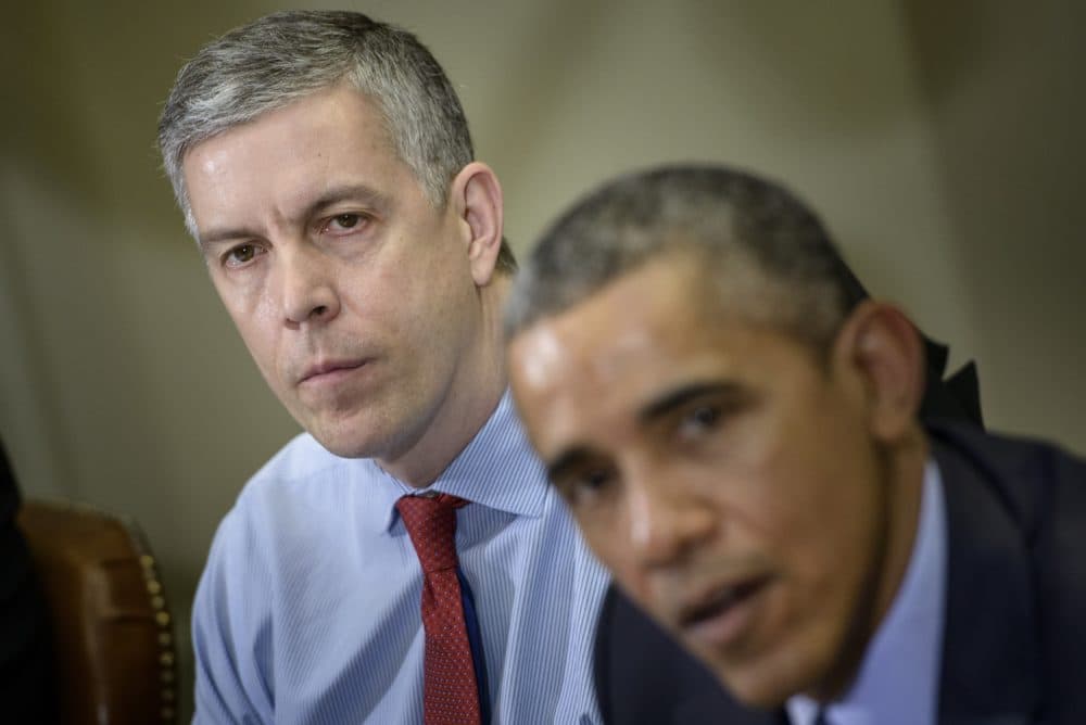 Former U.S. Secretary of Education Arne Duncan listens while former President Barack Obama makes a statement to the press in 2015. (Brendan Smialowski/AFP/Getty Images)