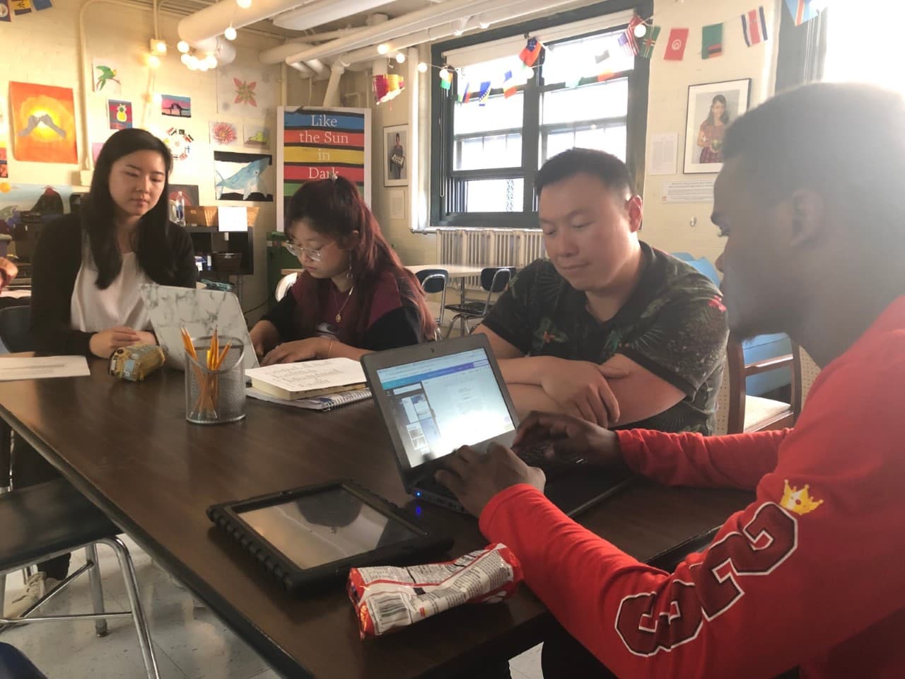 Ivan Ang, second from right, with students in the Writers' Room at Boston International Newcomers Academy. (Courtesy Ivan Ang)