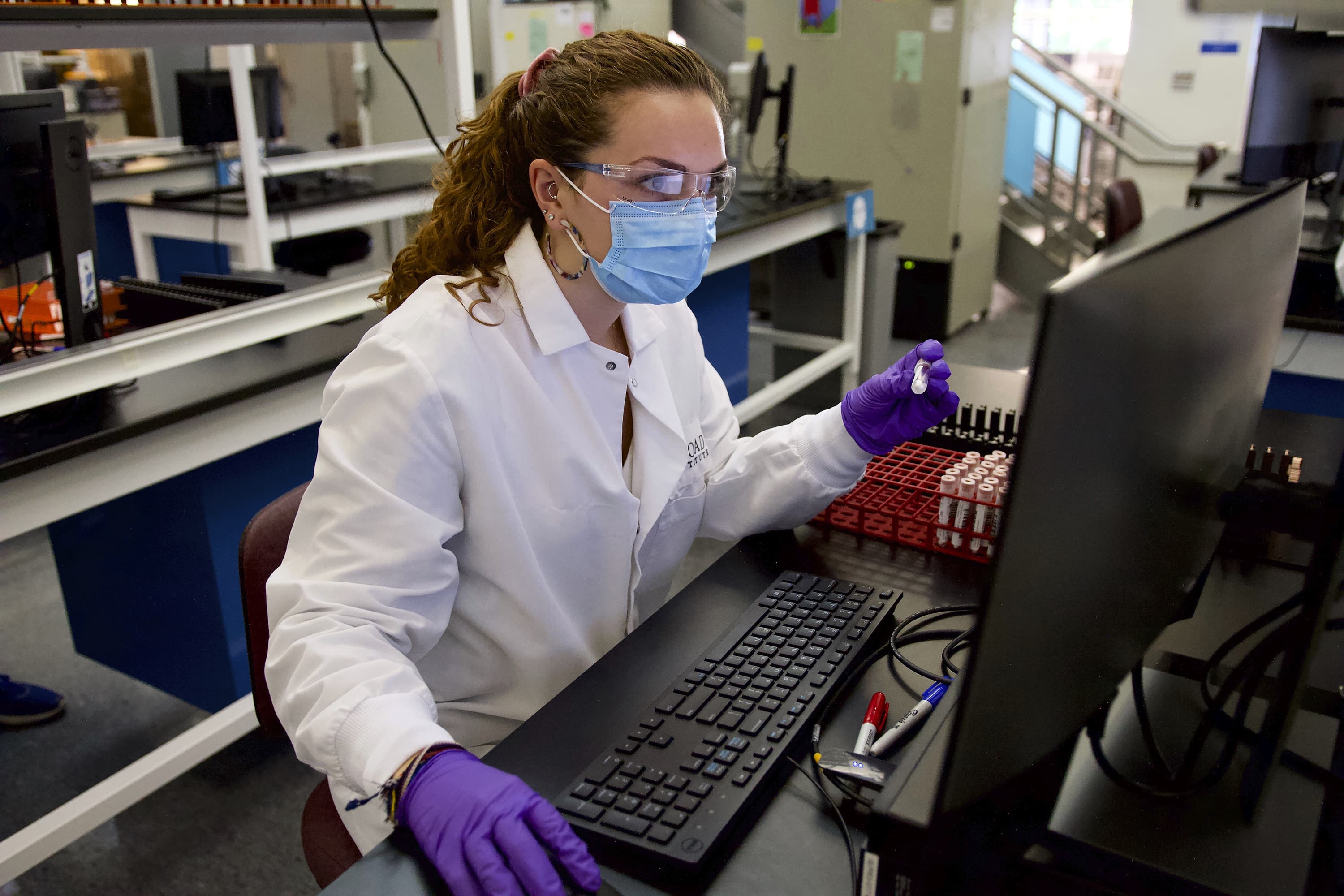A worker at the lab at the Broad Institute of MIT and Harvard processes coronavirus tests. (Courtesy Scott Sassone for the Broad Institute of MIT and Harvard)