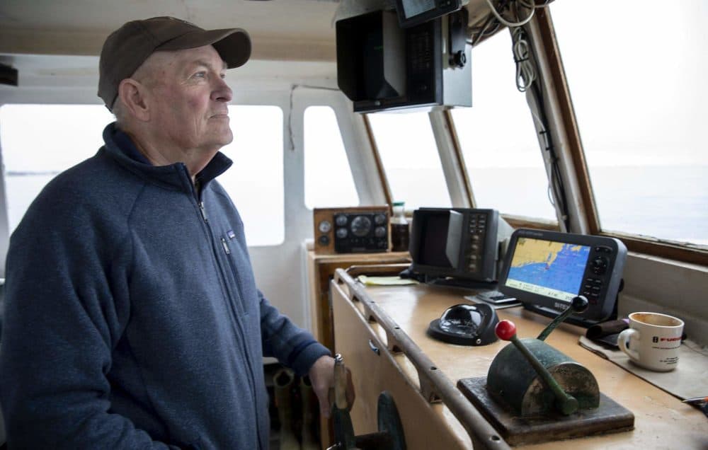 Lobsterman Mark Sweitzer steers his boat, the Erica Knight. (Robin Lubbock/WBUR)