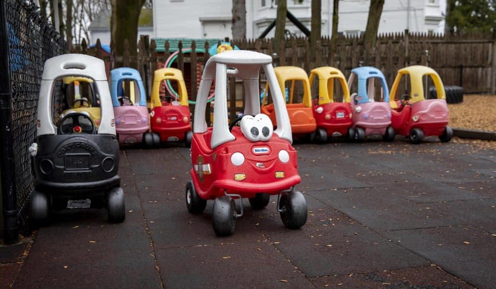 Children's vehicles parked at Waltham Day Care Center in March as providers closed as a precaution against the spread of COVID-19. (Robin Lubbock/WBUR)