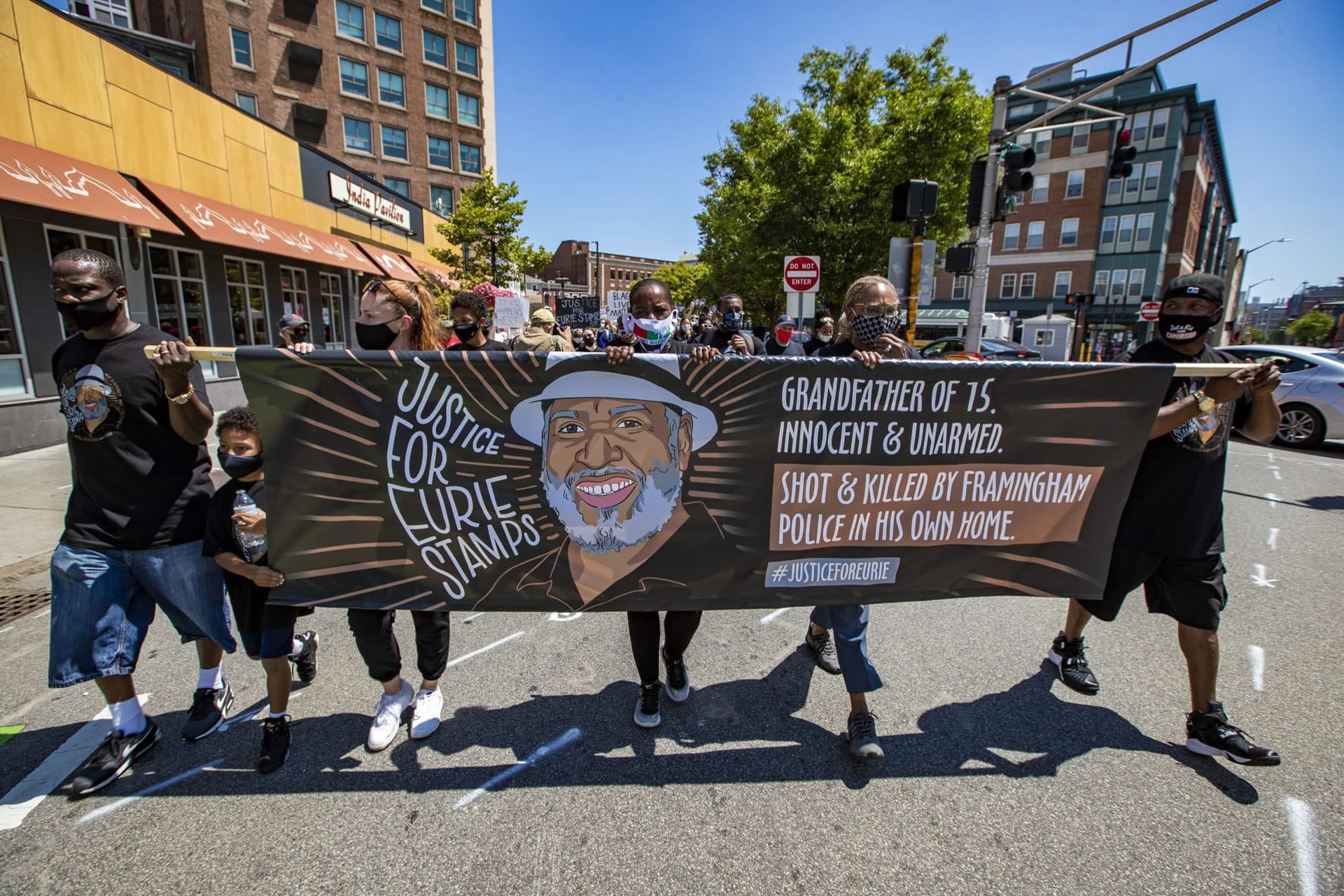 A &quot;Justice for Eurie [Stamps]&quot; march moves through Central Square in Cambridge on Aug. 1. Stamps grew up in Cambridge. He was killed by a Framingham police officer in 2011. (Jesse Costa/WBUR)