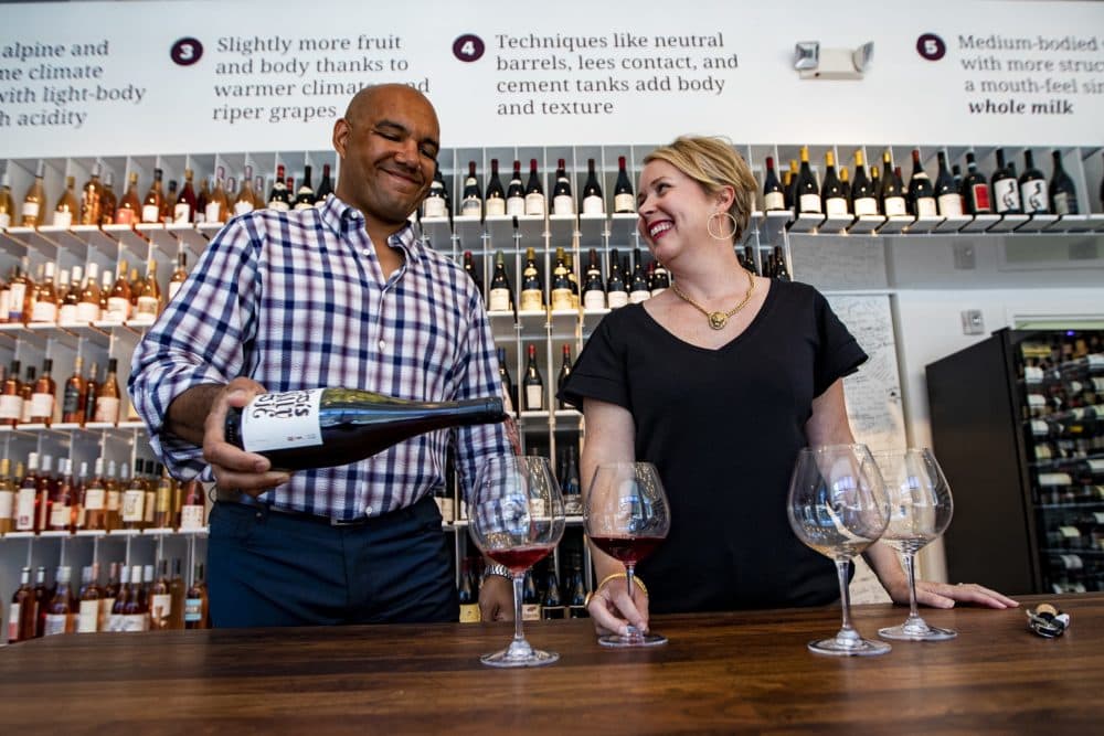 Urban Grape co-owners TJnDouglas and Hadley Douglas taste a J. Bouschon Pais Salvaje at the store. (Jesse Costa/WBUR)