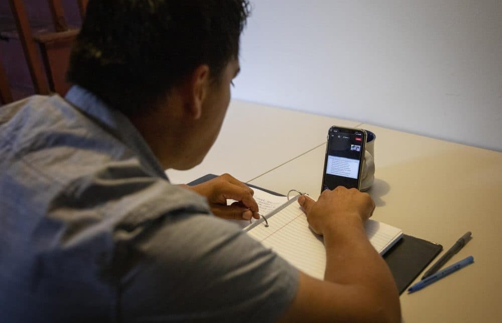 From his basement in Lynn, Edwin Rivera attends ESOL classes online. He has been developing his English skills with the goal of becoming a medical interpreter. (Robin Lubbock/WBUR)