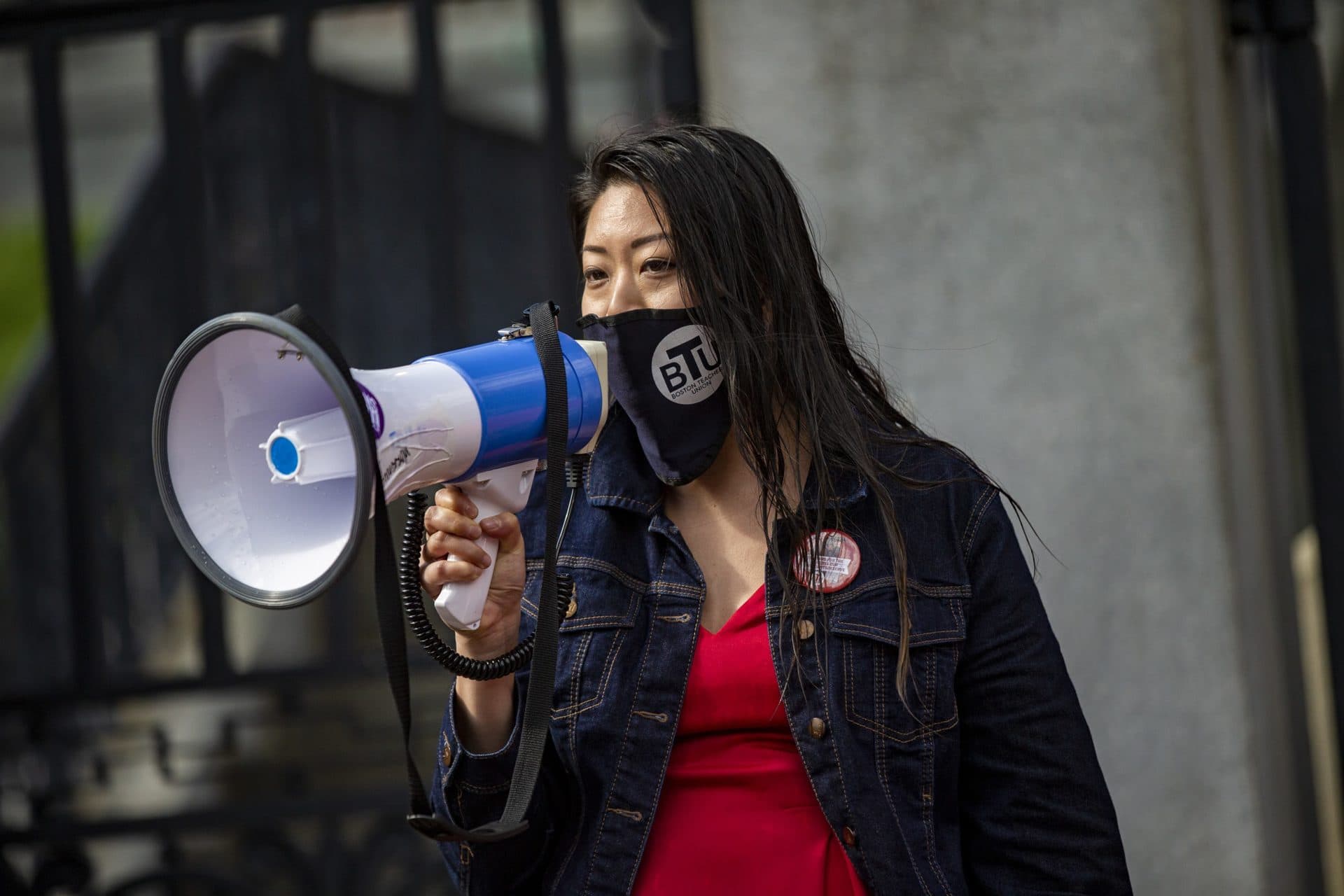 Boston Teachers Union president Jessica Tang speaks to the hundreds of members of the Massachusetts Teachers Union who attended the rally at the State House demanding Governor Charlie Baker to safely reopen schools. (Jesse Costa/WBUR)