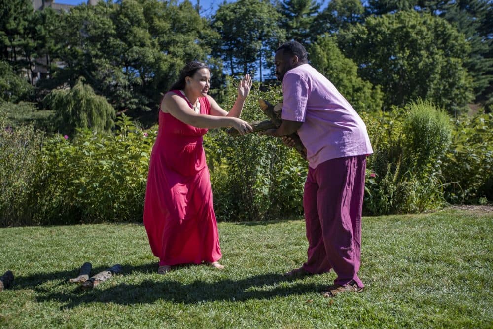 Paige Clark as Miranda, and Omar Robinson as Ferdinand rehearse the log scene in The Tempest at the Arnold Arboretum. (Jesse Costa/WBUR)