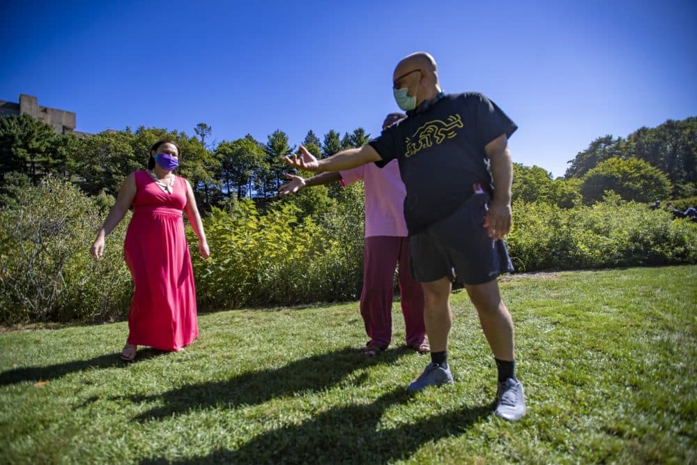 Artistic director Chris Edwards gives some direction to Omar Robinson during a rehearsal of the log scene in The Tempest at the Arnold Arboretum, one of a series of selected scenes, sonnets and monologues by the Actors' Shakespeare Project called &quot;The Nature of Shakespeare.&quot; (Jesse Costa/WBUR)