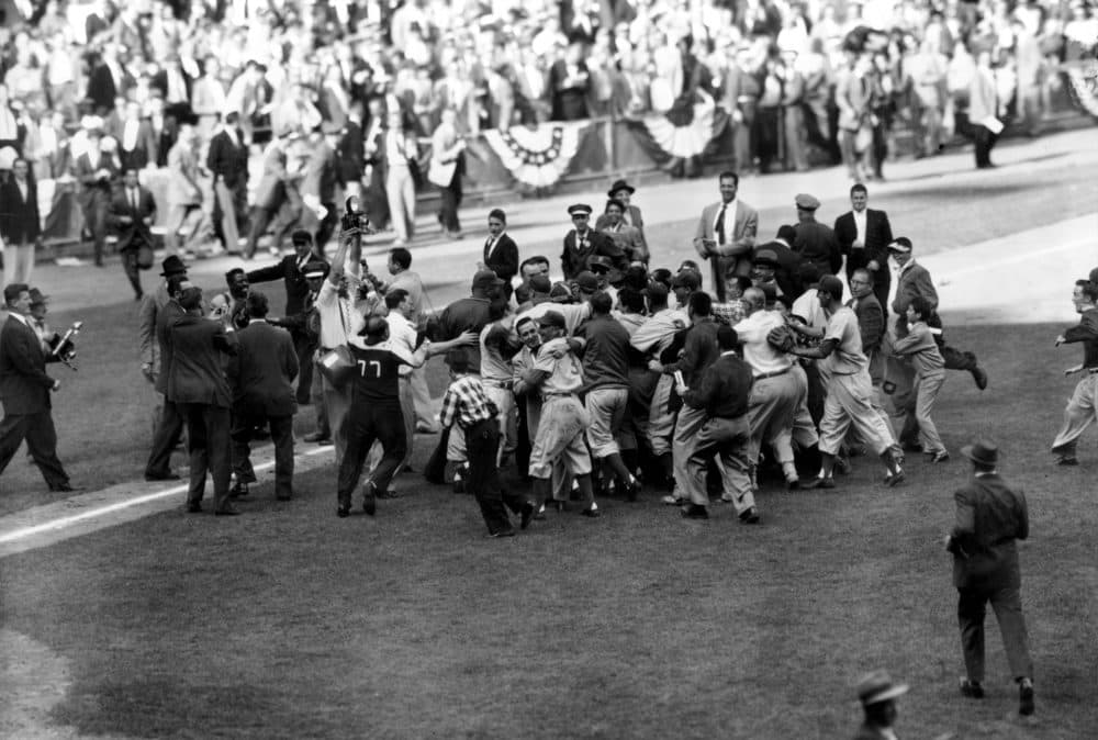 The Brooklyn Dodgers mob pitcher Johnny Podres after defeating the New York Yankees in the seventh and deciding game of the Subway Series to win the 1955 World Series. (AP Photo)