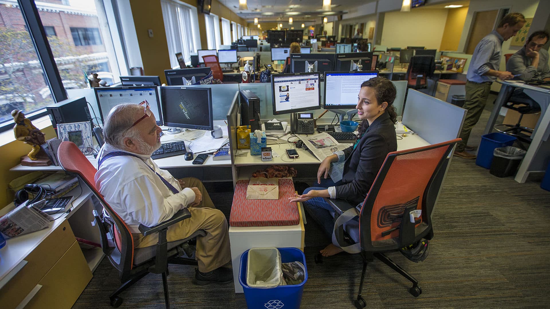 Former Morning Edition host Bob Oakes speaks with then-producer Yasmin Amer about upcoming interviews and projects. (Jesse Costa/WBUR)