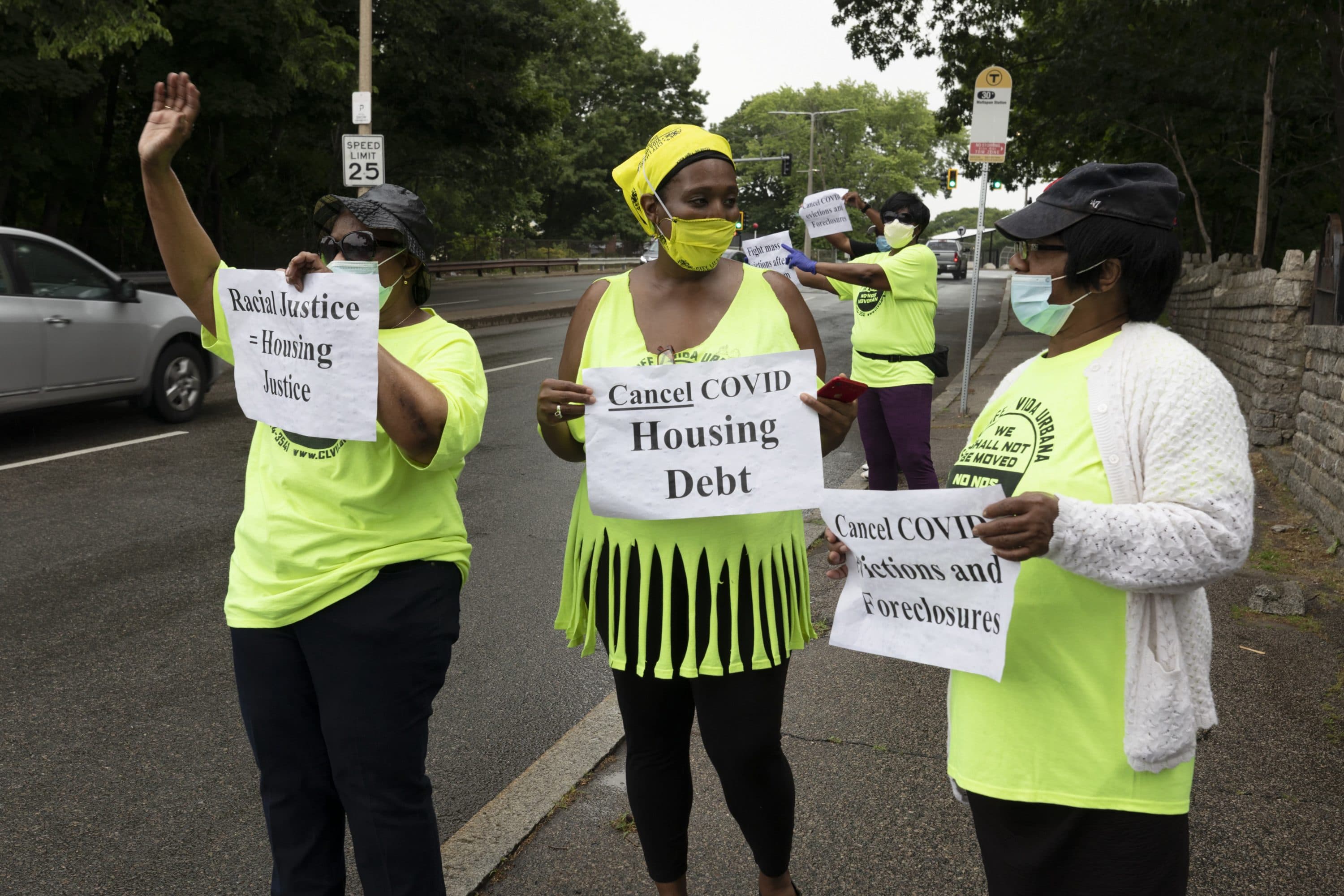 Annie Gordon, left, Gabrielle Rene, center, and Jenny Clark, right, rally for protection from evictions, June 27, 2020, in Mattapan. (Michael Dwyer/AP)