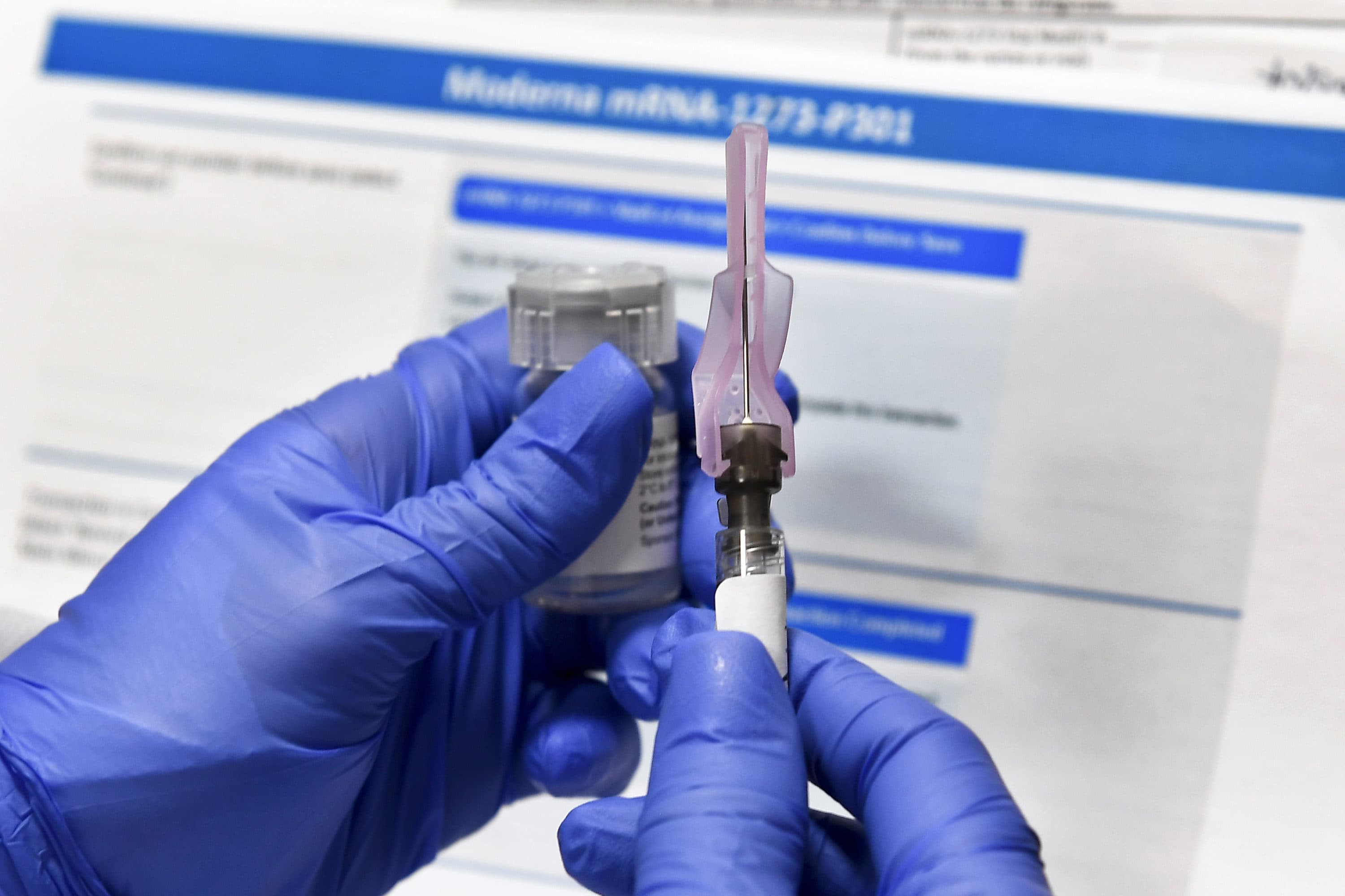 In this July 27, 2020 file photo, a nurse prepares a shot as a study of a possible COVID-19 vaccine, developed by the National Institutes of Health and Moderna Inc., gets underway in Binghamton, N.Y. (Hans Pennink/AP)
