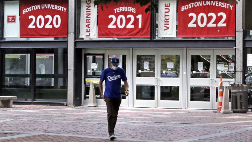Weston Koenn, a graduate student from Los Angeles, leaves the Boston University student union building as he walks through the student-less campus in Boston on July 23, 2020. (Charles Krupa/AP)