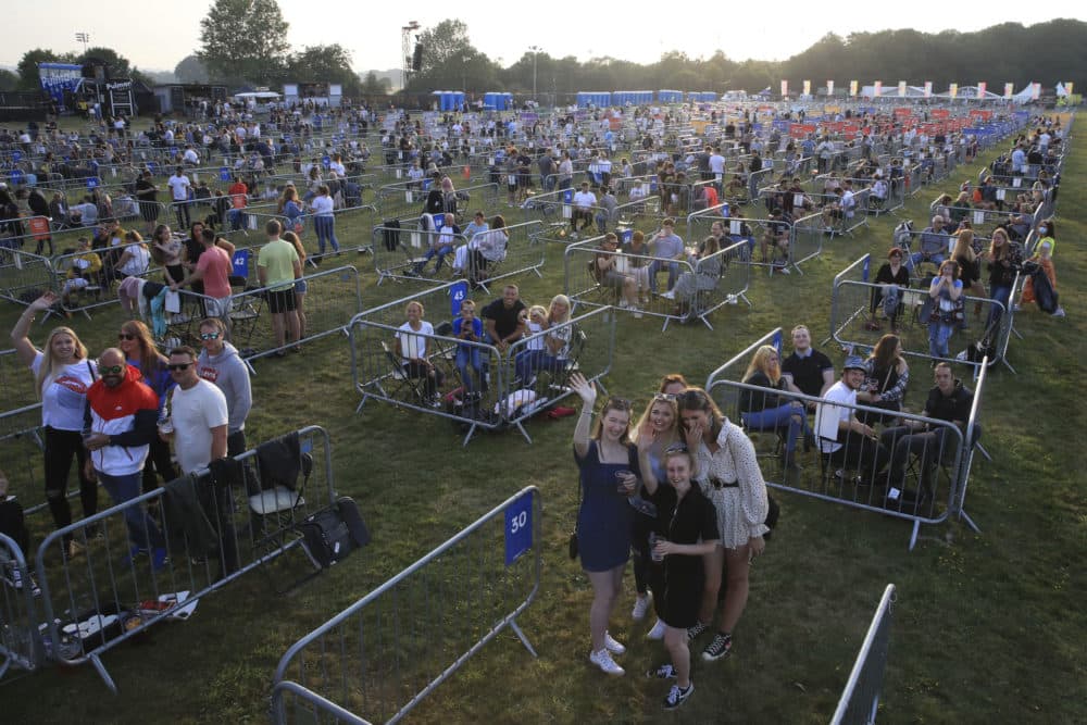 Fans occupy separate pens to force social distancing, ahead of the Sam Fender rock concert at the Virgin Money Unity Arena, a pop-up venue for the gig in Gosforth Park, Newcastle, northern England, Tuesday Aug. 11, 2020. (Owen Humphreys/PA via AP)