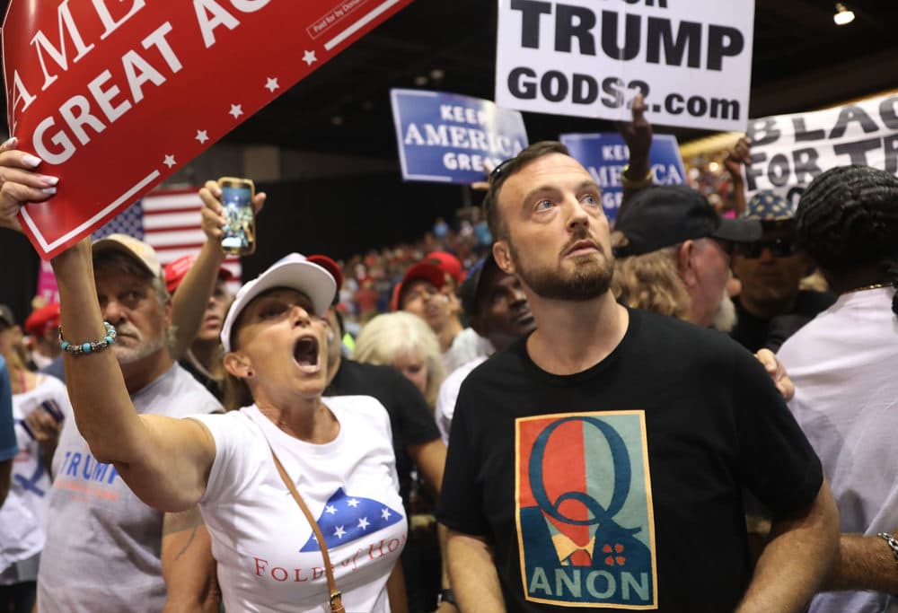A man wear a shirt with the words Q Anon as he attends a rally for President Donald Trump at the Make America Great Again Rally being held in the Florida State Fair Grounds Expo Hall on July 31, 2018 in Tampa, Florida. (Joe Raedle/Getty Images)